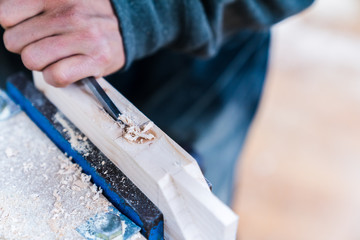 Technician handles a variety of woodworking tools to make wooden products. Both hand and machine tools are used after carpenters measure exact size by different types of rulers.