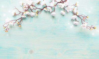 White flowers on blue wooden background