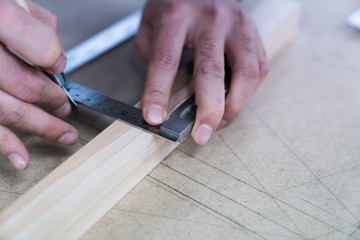 Technician handles a variety of woodworking tools to make wooden products. Both hand and machine tools are used after carpenters measure exact size by different types of rulers.