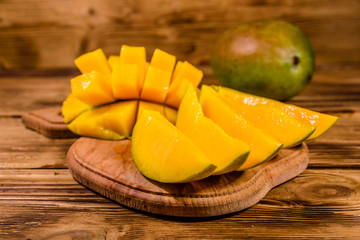 Cutting board with chopped mango fruit on a wooden table