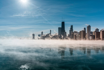 Chicago Downtown skyline during winter polar vortex .Fog drifts across Lake Michigan