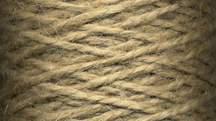 Natural jute twine roll, skein of jute thread texture. micro shot of a coil of jute twine. Supplies and tools for handmade hobby leisure closeup.