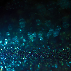 blue glitter magic background. Defocused light and free focused place for your design.