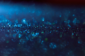 blue glitter magic background with dark gradient. Defocused light and free focused place for your design.