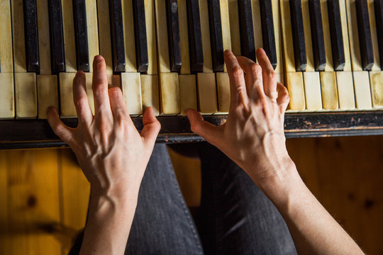 Close Up Fingers Of Woman Pianist At The Rusty Piano Keys, Arms Plays Solo Of Music. Hands Of Female Musician Playing, Overhead Shot