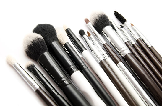 Various set of professional makeup brushes isolated over white