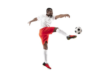 Fototapeta na wymiar Professional african american football soccer player in motion isolated on white studio background. Fit jumping man in action, jump, movement at game.