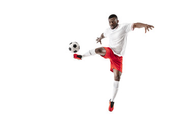 Professional african american football soccer player in motion isolated on white studio background. Fit jumping man in action, jump, movement at game.