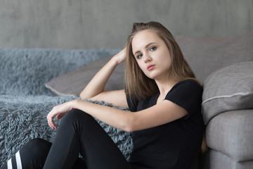 Attractive young woman near sofa