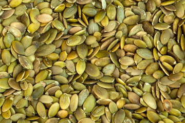Peeled pumpkin seeds    pattern. Macro background texture of green pumpkin seeds