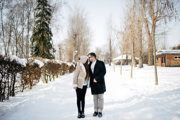 Young Beautiful Couple Taking Fun and Smiling Outdoors in Snowy Winter