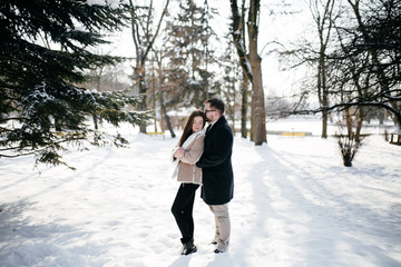 Young Beautiful Couple Taking Fun and Smiling Outdoors in Snowy Winter