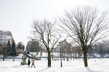Young Beautiful Couple Taking Fun and Smiling Outdoors in Snowy Winter