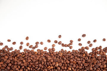  Textured brown coffee beans on a white background.