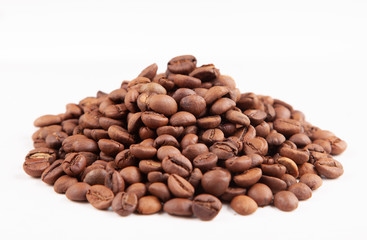  Textured brown coffee beans on a white background.