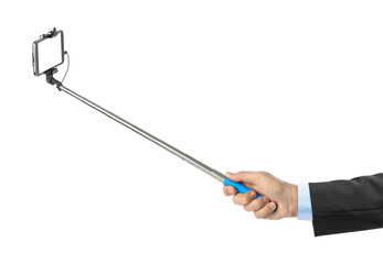 Hand and smartphone with selfie stick