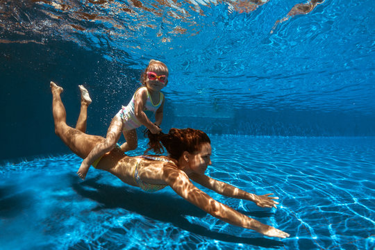 underwater image of a mam and a girl