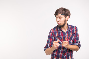 Expression and gesture concept - young bearded man in plaid shirt over white background with copy space