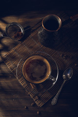 Obraz na płótnie Canvas Cup of black coffee on the table with cream