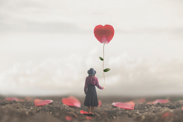 samotna romantyczna kobieta trzyma w sercu gigantyczny płatek - 247297597