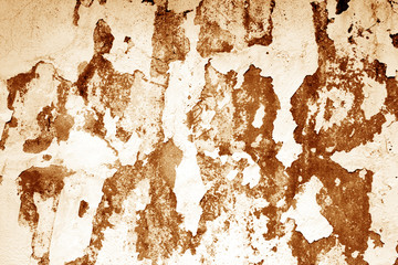 Сraked weathered cement wall texture in orange tone.