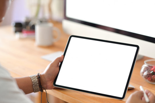 Cropped Shot Of  Businessman Sitting And Woking With Tablet In Office