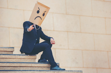 Businessman masked stress on the company stairs.
