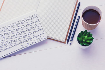 top view image of open notebook with blank pages next to cup of coffee on wooden table. ready for...