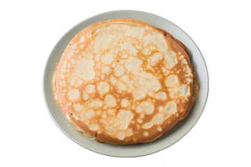 Thin pancakes on a plate isolated on a white background.