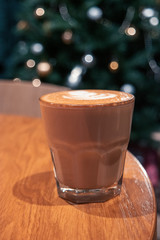 Transparent glass of cappuccino or flat-white coffee
