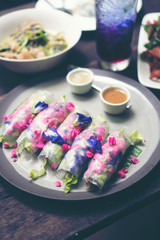 Fresh vegetable salad, fruit and flowers, healthy fusion food