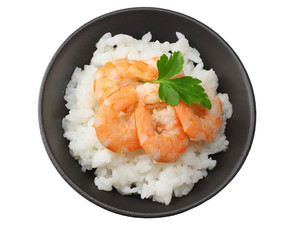 White rice with shrimps in black bowl isolated on white background. top view