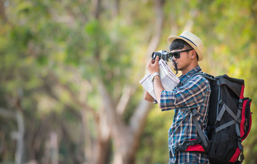 Tourists with backpacks are taking photos. On the road in the woods