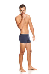 Shirtless handsome man in panties on white background