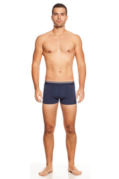 Shirtless handsome man in panties on white background