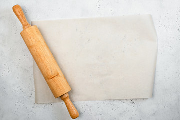 Rolling pin and baking paper background with copy space for text, recipe, menu. Baking or cooking food background