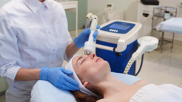 Relaxed woman lies on a table and getting a treatment. Wellness. Health care