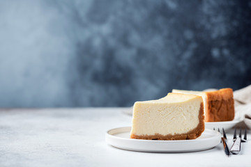 Classical Plain New York Cheesecake Over Blue Concrete Background. Copy Space For Text - obrazy, fototapety, plakaty