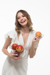 attractive smiling  young woman holding red apples. white background