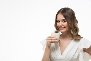 One beautiful healthy woman holding a glass of milk. white background