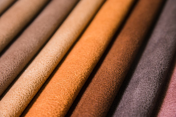 Colorful and bright fabric samples of furniture and clothing upholstery. Close-up of a palette of textile abstract stripes of different colors