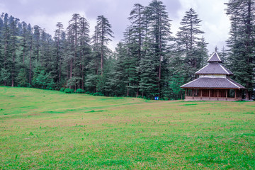 A Temple in Green meadows in himalayas, Great Himalayan National Park, Sainj Valley, Himachal Pradesh, India