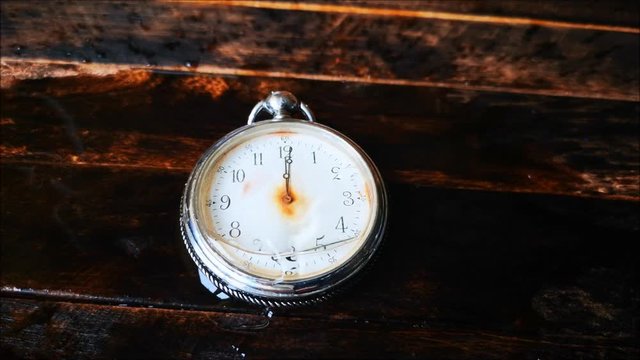 the water flows on the broken vintage pocket watches
