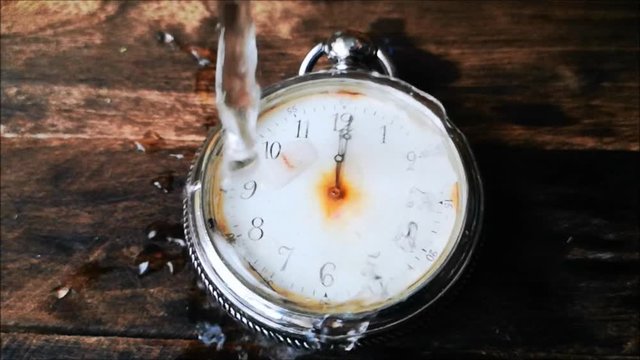 the water flows on the broken vintage pocket watches
