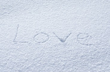 The inscription love in the snow, the symbol of Valentine's Day