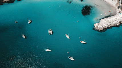 Fototapeta na wymiar Aerial shot of beautiful blue lagoon at hot summer day with sailing boat. Top view.