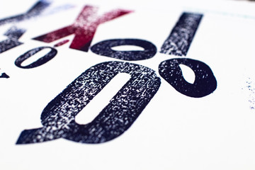 letters printed with movable type and traditional letterpress printing. blue and red letters...
