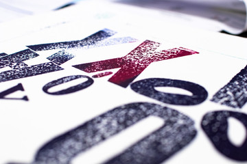 letters printed with movable type and traditional letterpress printing. blue and red letters printed with letterpress on white sheet. Typographic crafts and printed graphics for posters art