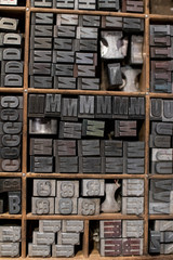 typographic mobile characters collected in a drawer for typography. collection of antique letterpress art pieces with movable characters. elements of a typography to print letters