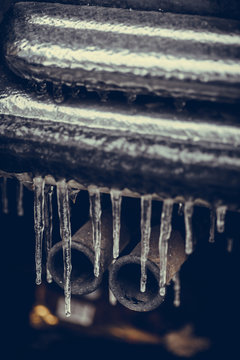 Icicles on the exhaust pipe of a car